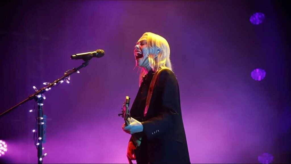  A collage featuring Phoebe Bridgers' 'Stranger in the Alps' and 'Punisher' album covers alongside a dynamic live concert photo