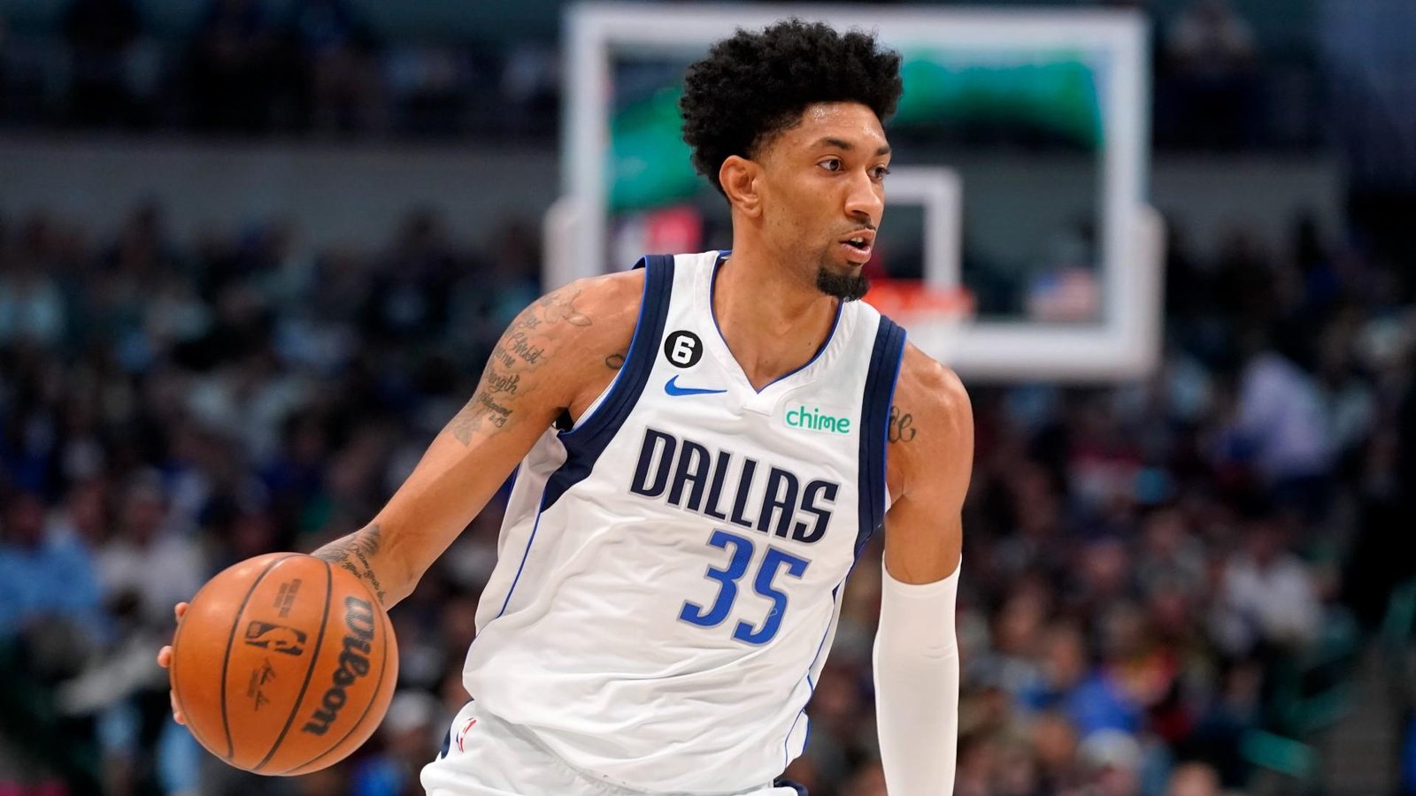 Christian Wood in a Dallas Mavericks jersey, preparing to take a shot during a game.