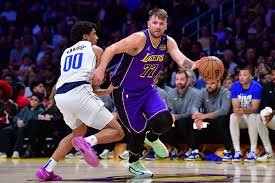 Dallas Mavericks and Los Angeles Lakers players in action during the game.