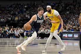 Luka Dončić driving past defenders toward the hoop