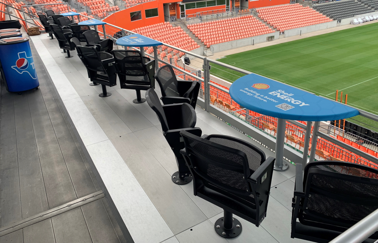 A luxurious VIP hospitality lounge with elegant seating, gourmet food, and a premium view of the sports event.