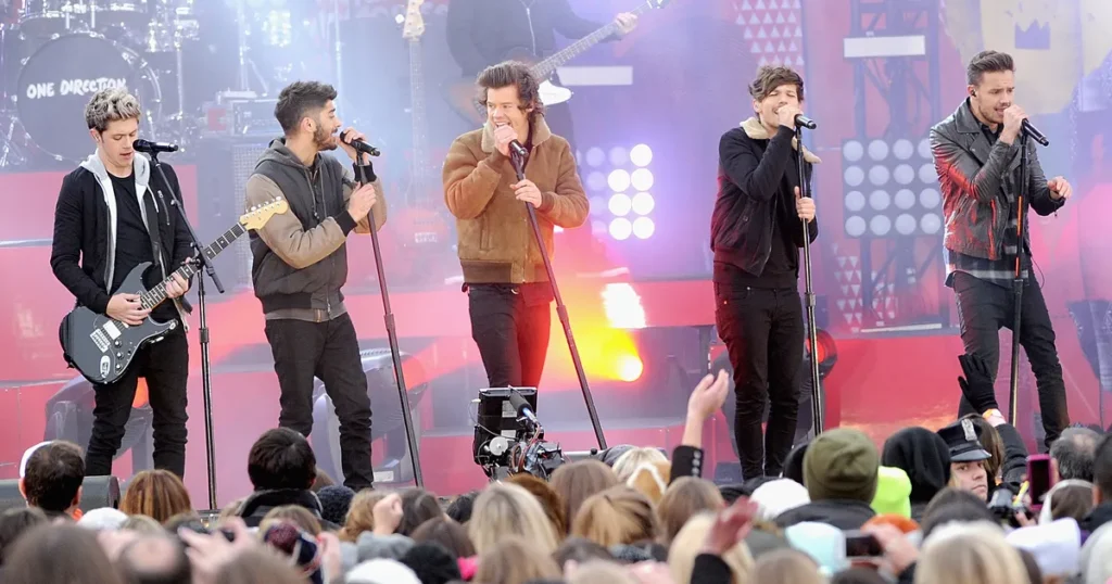 One Direction members performing on stage during their prime years.