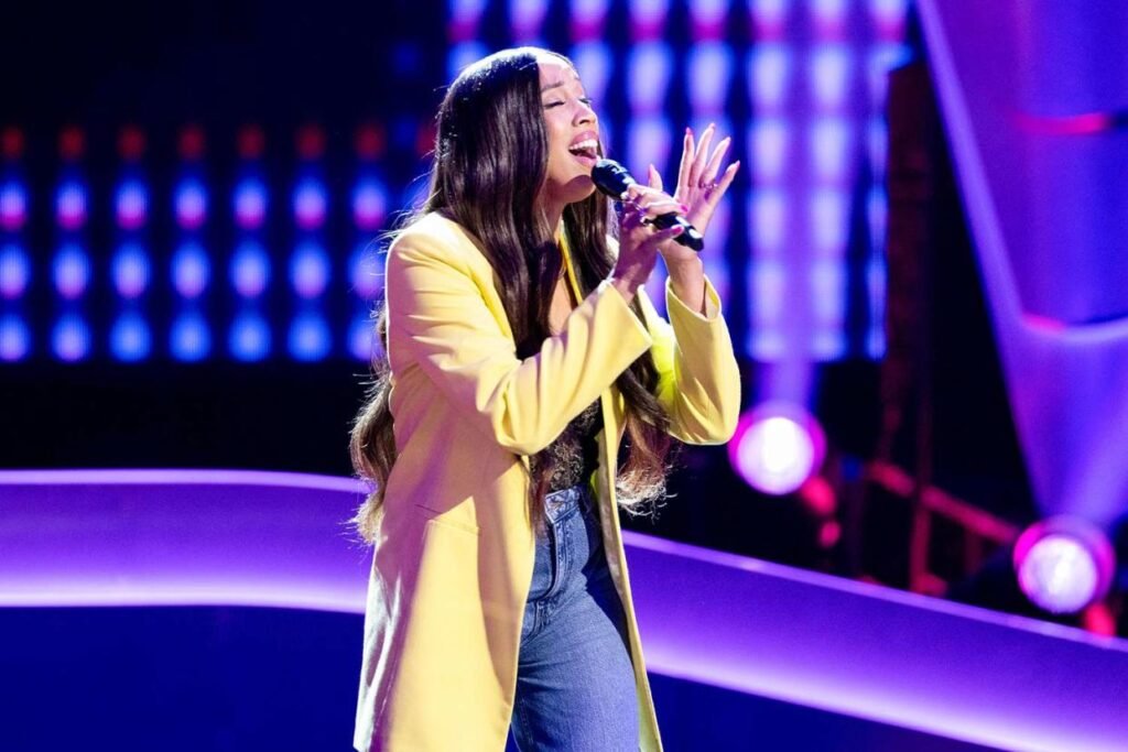 A contestant singing on The Voice stage