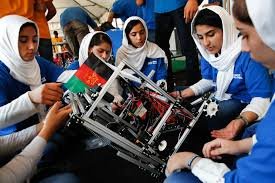 Afghan girls assembling a robot as part of their STEM education.