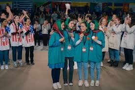 A group of Afghan girls posing together as part of the Rule Breakers robotics team.
