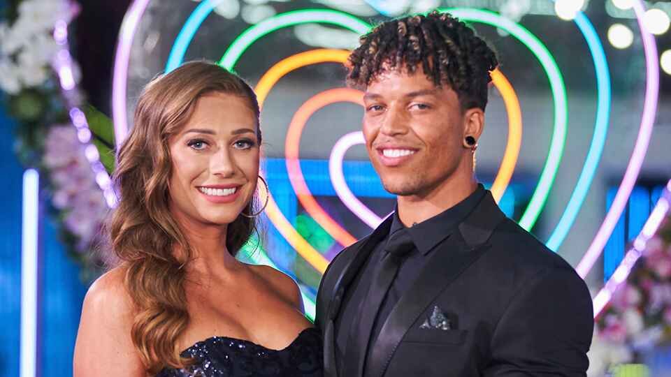 Korey Gandy and Olivia Kaiser smiling and holding hands after winning Love Island USA Season 3