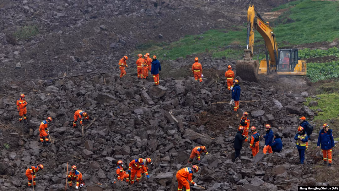 Rescue workers search for survivors after the southwest China landslide disaster