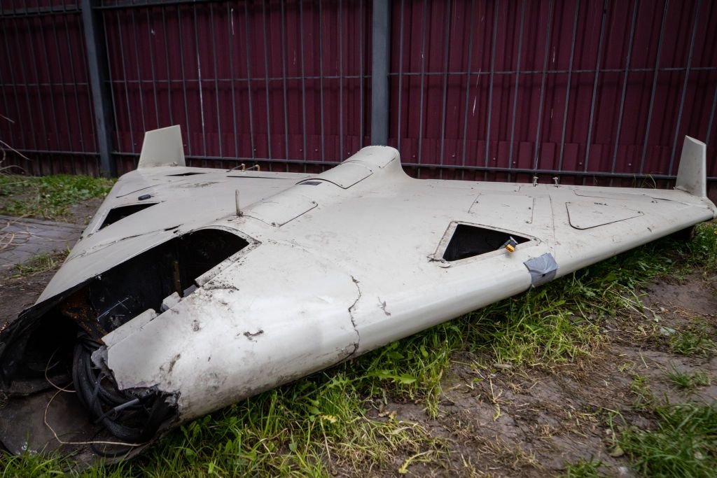 Destroyed Shahed-type drone debris on the ground.