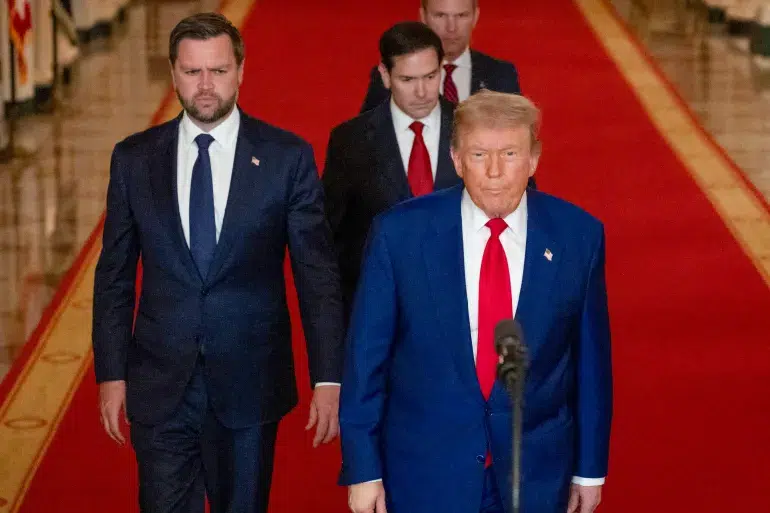 Donald Trump walks with U.S. officials after claiming ceasefire in the Israel-Iran conflict